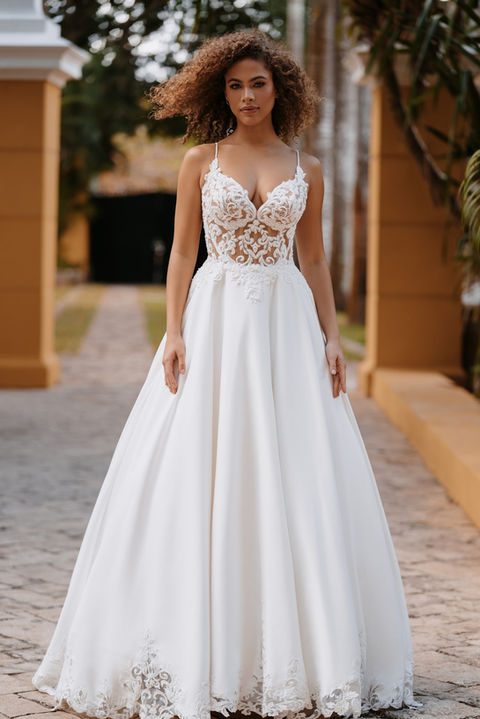 outdoor photo of woman wearing white allure couture designer wedding dress