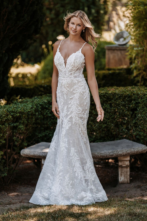 outdoor photo of woman wearing white allure couture designer wedding dress