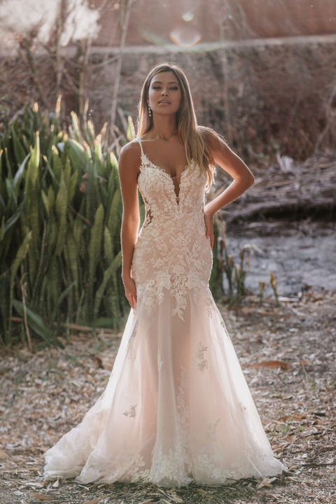 outdoor photo of woman wearing white allure romance designer wedding dress