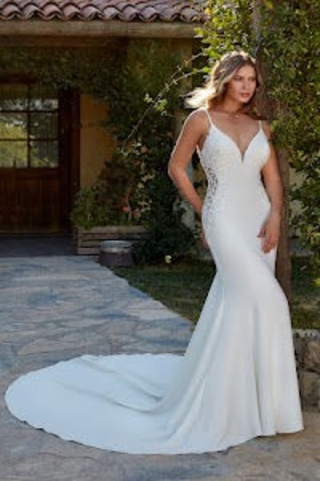 outdoor photo of woman wearing white designer eddy k wedding dress