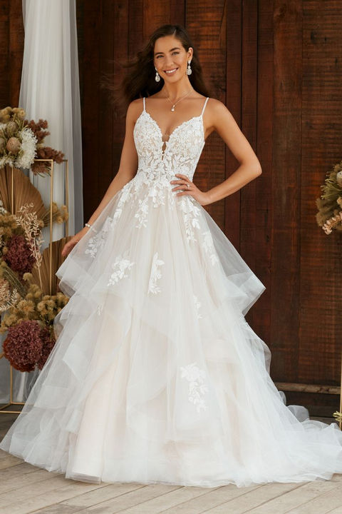 indoor photo of woman wearing white designer sophia tolli wedding dress