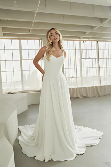 woman wearing white madi lane designer wedding dress indoors